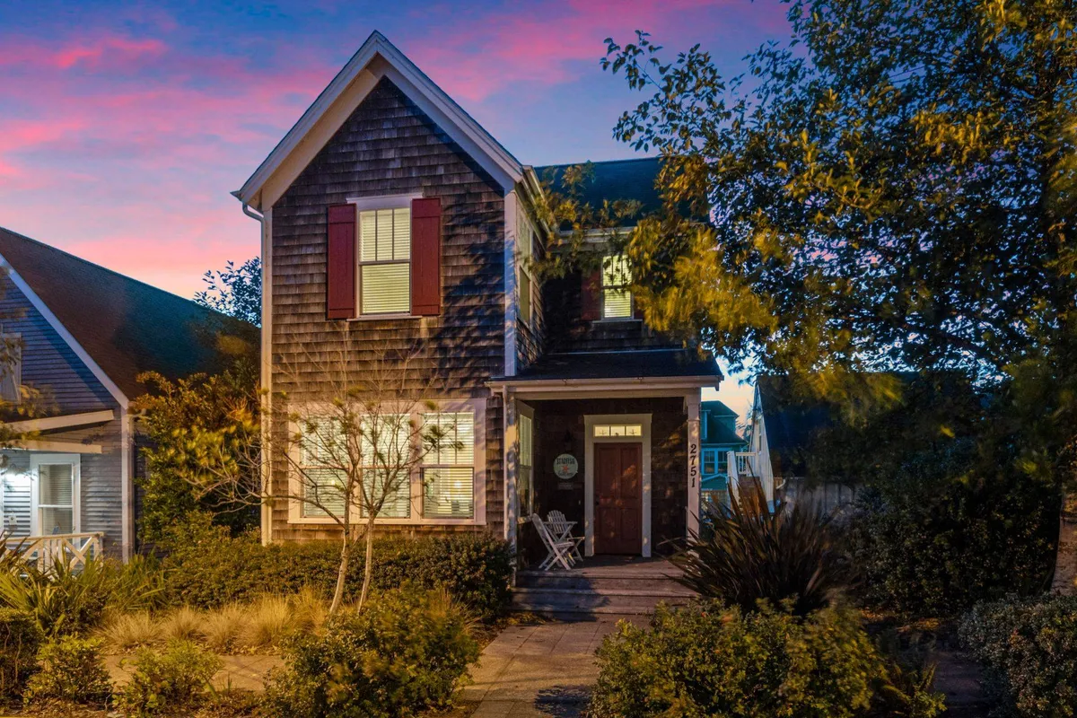 The image showcases the charming exterior of Starfish Cottage, with inviting shuttered windows, a welcoming front door, and a beautifully landscaped garden. The cozy porch is perfect for relaxing, while soft evening light hints at peaceful sunset gatherings.